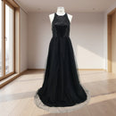 Black evening gown with sequined top on a white background
