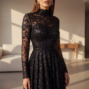 Person wearing a black sequin dress against a neutral background