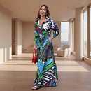 Woman wearing a colorful patterned dress standing on a sidewalk.
