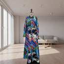 Colorful dress with abstract patterns on a mannequin against a plain background