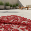 Close-up of red embroidered fabric with intricate patterns and beads