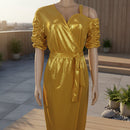 Gold metallic jumpsuit on a mannequin against a plain background