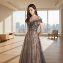 Woman wearing a glamorous evening gown with floral embellishments on a plain background
