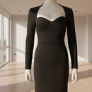 Black dress on a mannequin against a white background