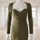 Green evening gown on a mannequin against a white background