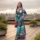 Woman wearing a colorful patterned dress standing on a sidewalk.